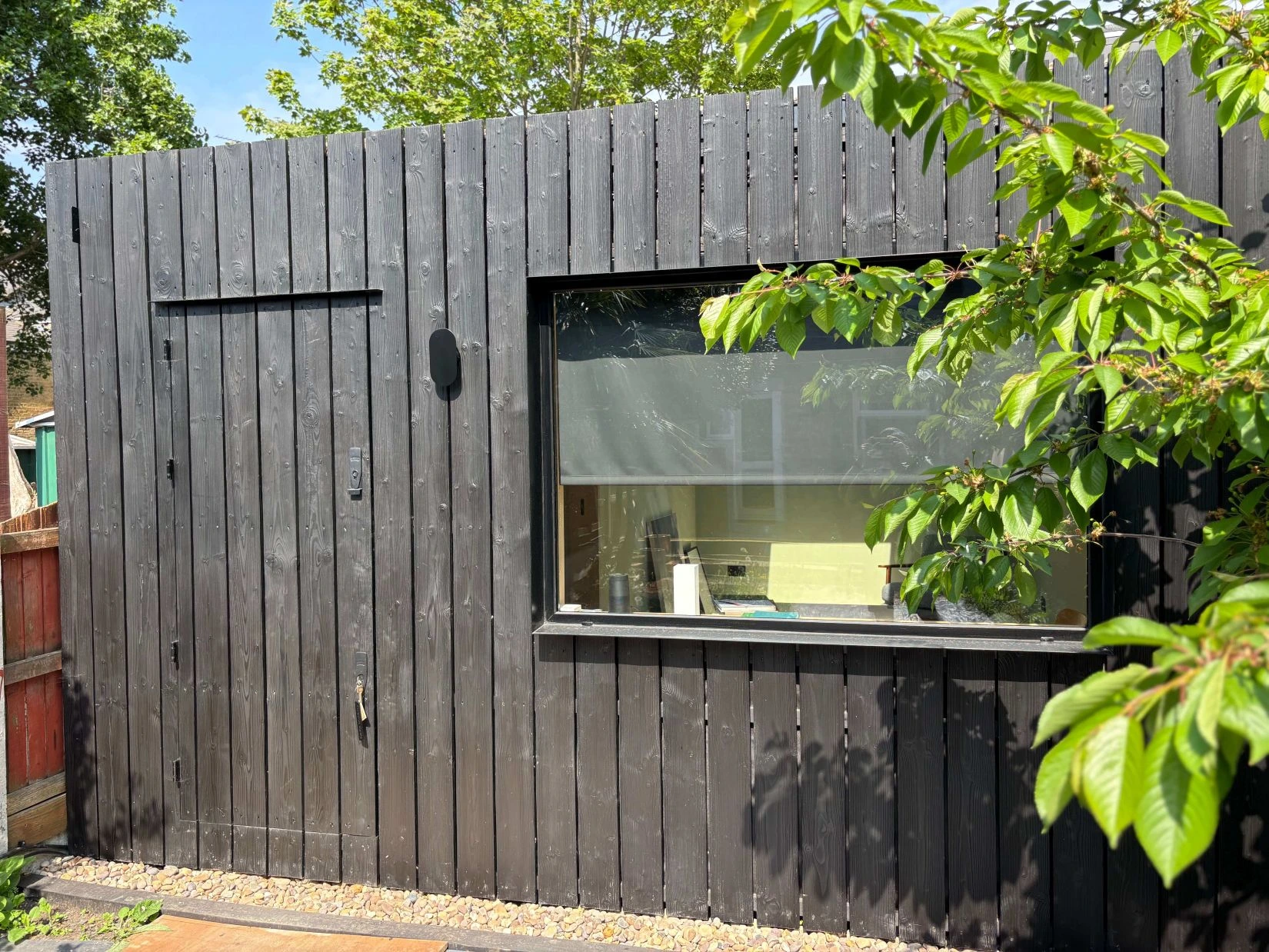 Home office studio in charred timber with large window